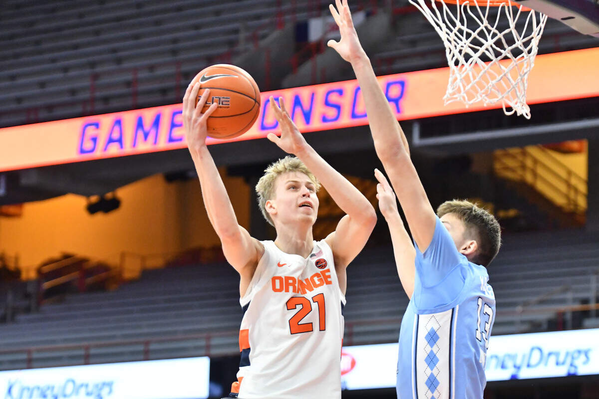 Mar 1, 2021; Syracuse, New York, USA; Syracuse Orange forward Marek Dolezaj (21) shoots the ball as North Carolina Tar Heels forward Walker Kessler (13) defends in the first half at the Carrier Dome.