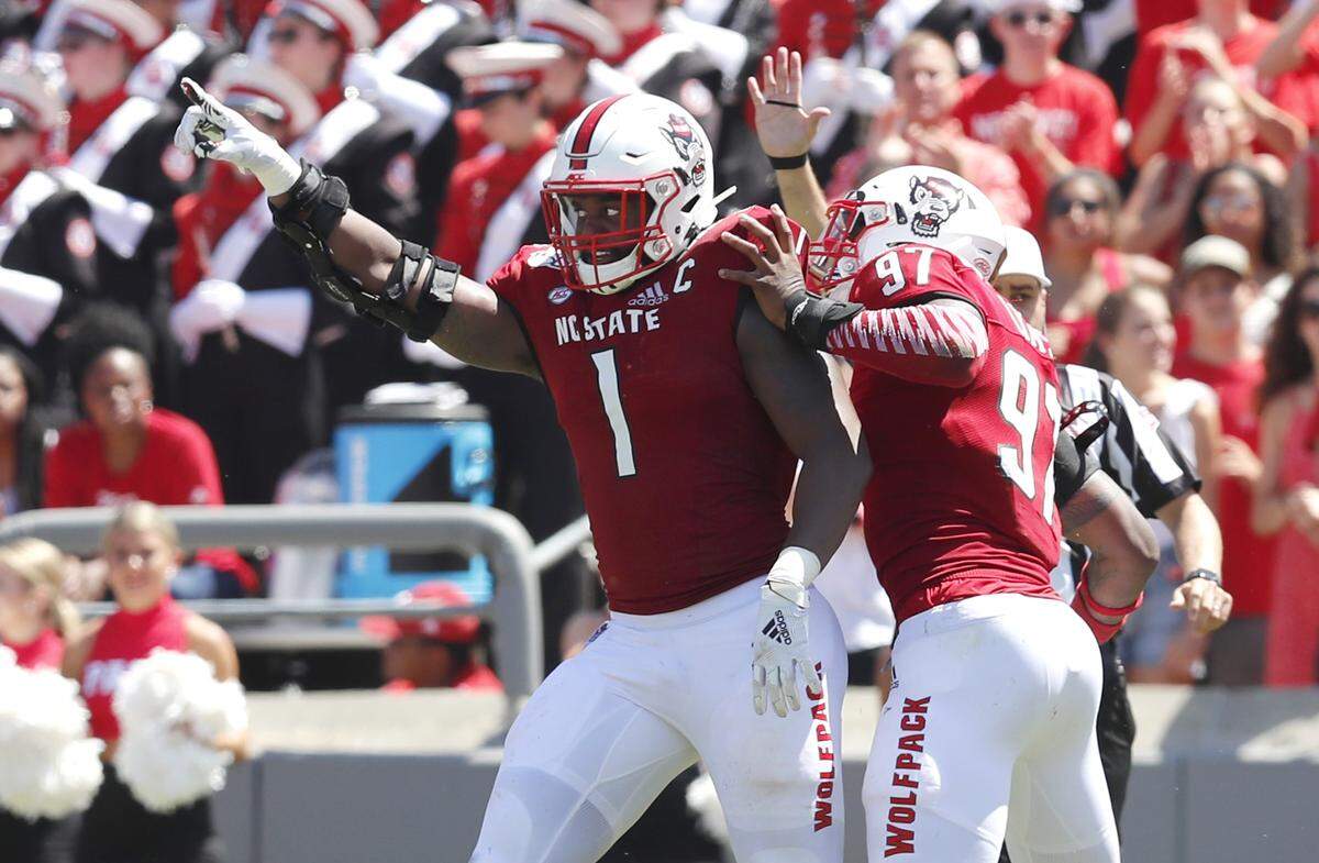 N.C. State’s Xavier Lyas (97), right, celebrates with James Smith-Williams (1) after Smith-Williams sacked East Carolina quarterback Holton Ahlers during the first half of N.C. State’s game against East Carolina University at Carter-Finley Stadium in Raleigh, N.C., Saturday, August 31, 2019.