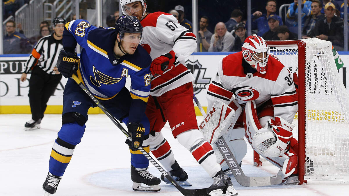 St. Louis Blues’ Alexander Steen, left, battles with Carolina Hurricanes’ Trevor van Riemsdyk for position in front of goaltender Curtis McElhinney during the second period of an NHL hockey game Tuesday, Nov. 6, 2018, in St. Louis.