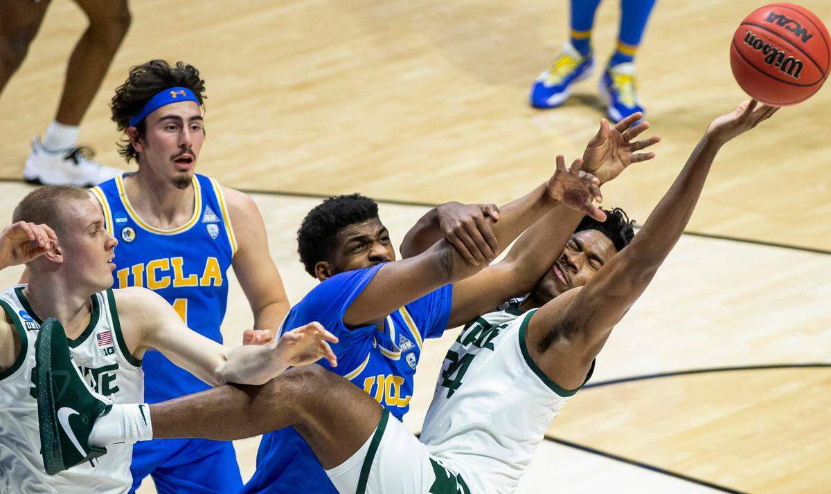 Michigan State’s Julius Marble II (34) competes for a rebound with UCLA’s Cody Riley, center, next to Michigan State’s Joey Hauser, left, and UCLA’s Jaime Jaquez Jr. (4) during the first half of a First Four game in the NCAA men’s college basketball tournament, Thursday, March 18, 2021, at Mackey Arena in West Lafayette, Ind. (AP Photo/Robert Franklin)