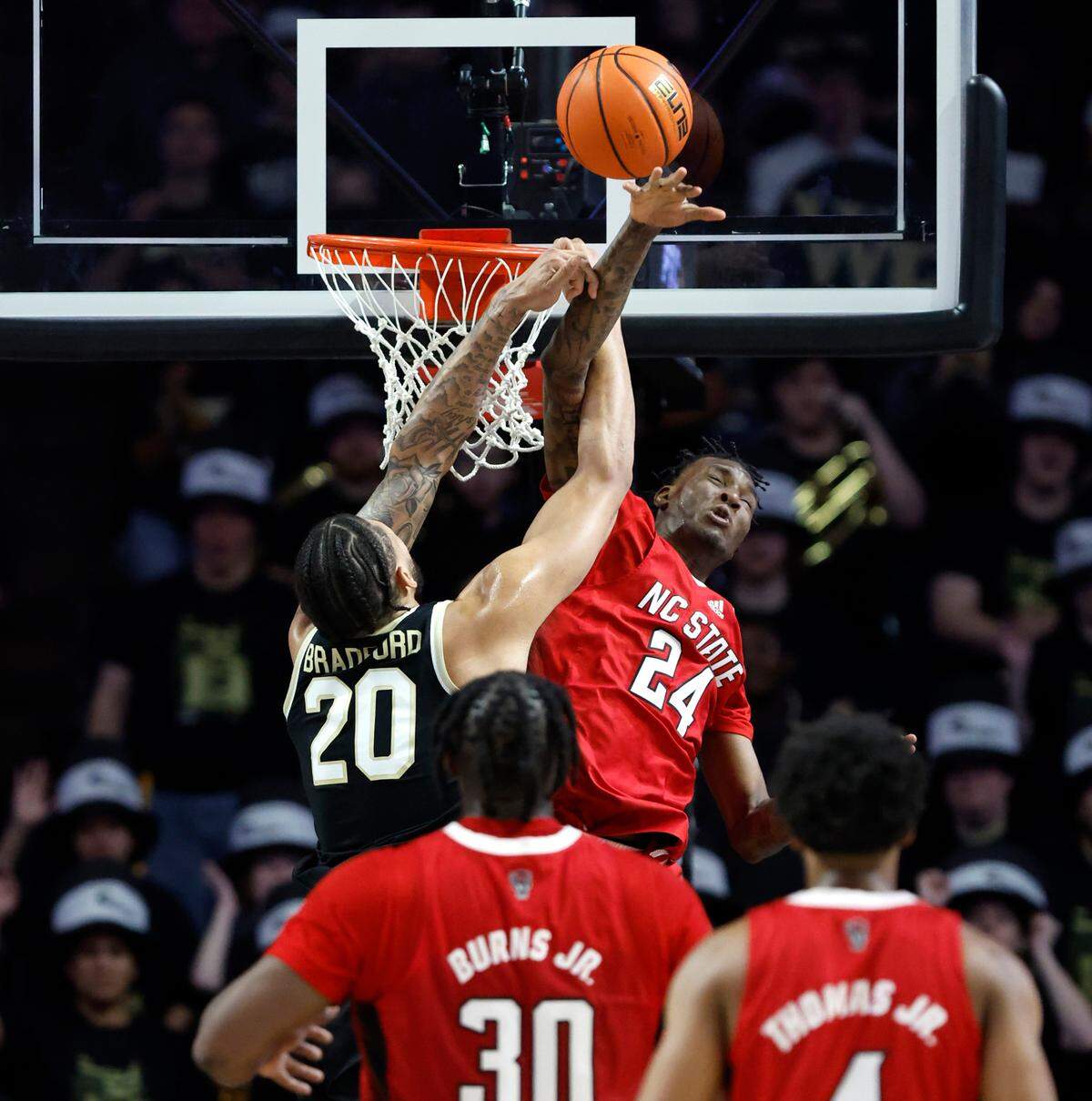 N.C. State’s Ernest Ross (24) blocks the slam by Wake Forest’s Davion Bradford (20) during the first half of N.C. State’s game against Wake Forest at Joel Coliseum in Winston-Salem, N.C., Saturday, Jan. 28, 2023.