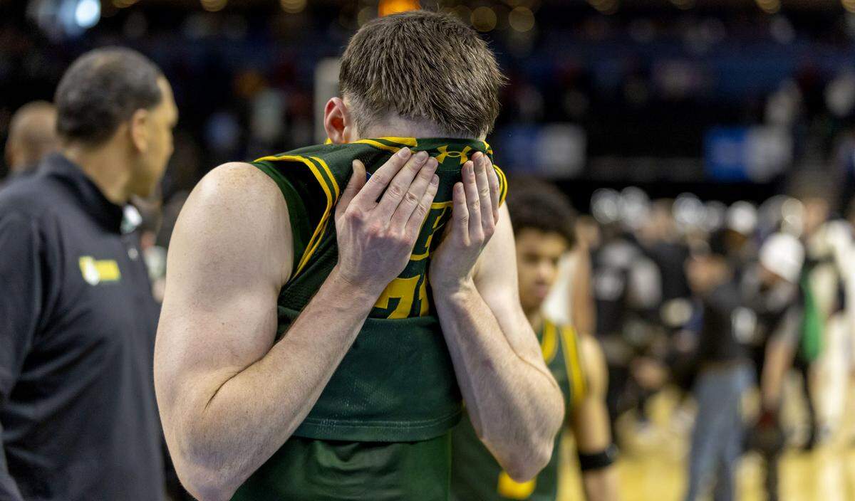 Siena forward Brendan Coyle (21) covers his face as he leaves the court following their 71-65 loss to Duke on Thursday, March 18, 2026, during the first round of the NCAA Tournament at Bon Secours Arena in Greenville, S.C.