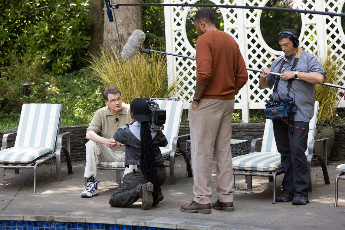 Colin Firth (seated) as Michael Peterson and Vincent Vermingnon (standing) as Jean-Xavier de Lestrade in the HBO Max series “The Staircase.”