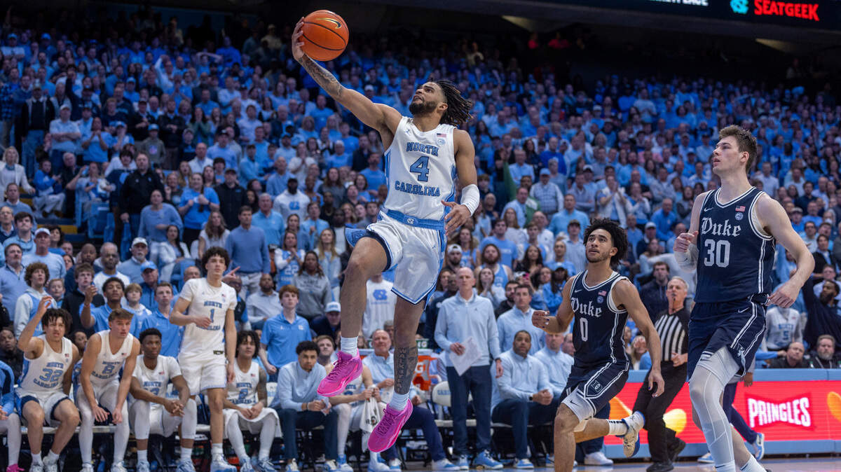 North Carolina’s R.J. Davis (4) breaks to the basket past Duke’s Jared McCain (0) and Kyle Filipowski (30) in the second half on Saturday, February, 3, 2024 at the Dean E. Smith Center in Chapel Hill, N.C.