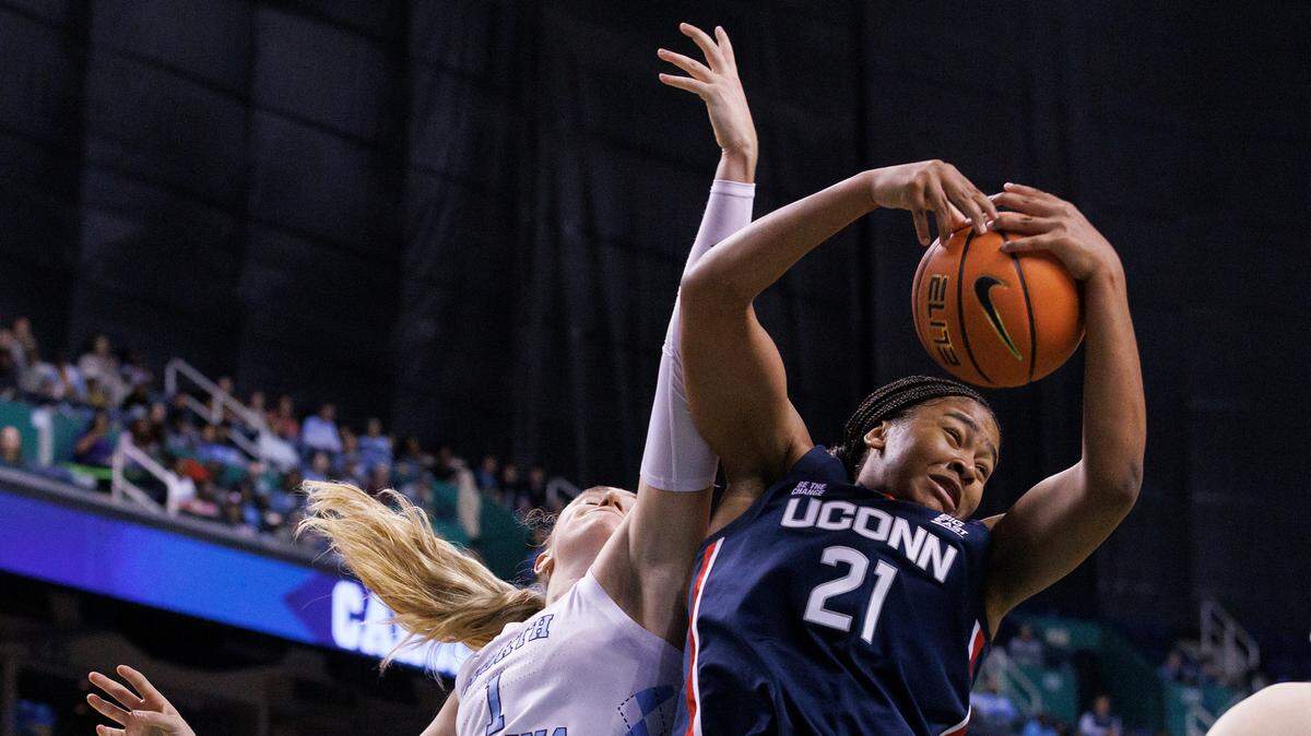 UConn’s Sarah Strong pulls down a rebound away from North Carolina’s Alyssa Ustby during the second half of the Tar Heels’ 69-58 loss on Friday, Nov. 15, 2024, at First Horizon Coliseum in Greensboro, N.C.