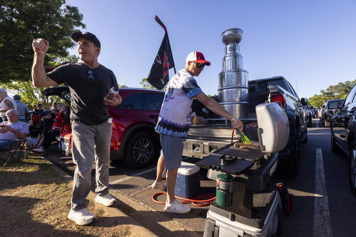 Carolina Hurricanes fans tailgate in the parking lot at the Lenovo Center in Raleigh on Tuesday, June 2, 2026, before Game 1 of the Stanley Cup Final. For the first time since 2006, the Hurricanes are playing in the Stanley Cup Final, facing the Vegas Golden Knights, who won the Stanley Cup in 2023.