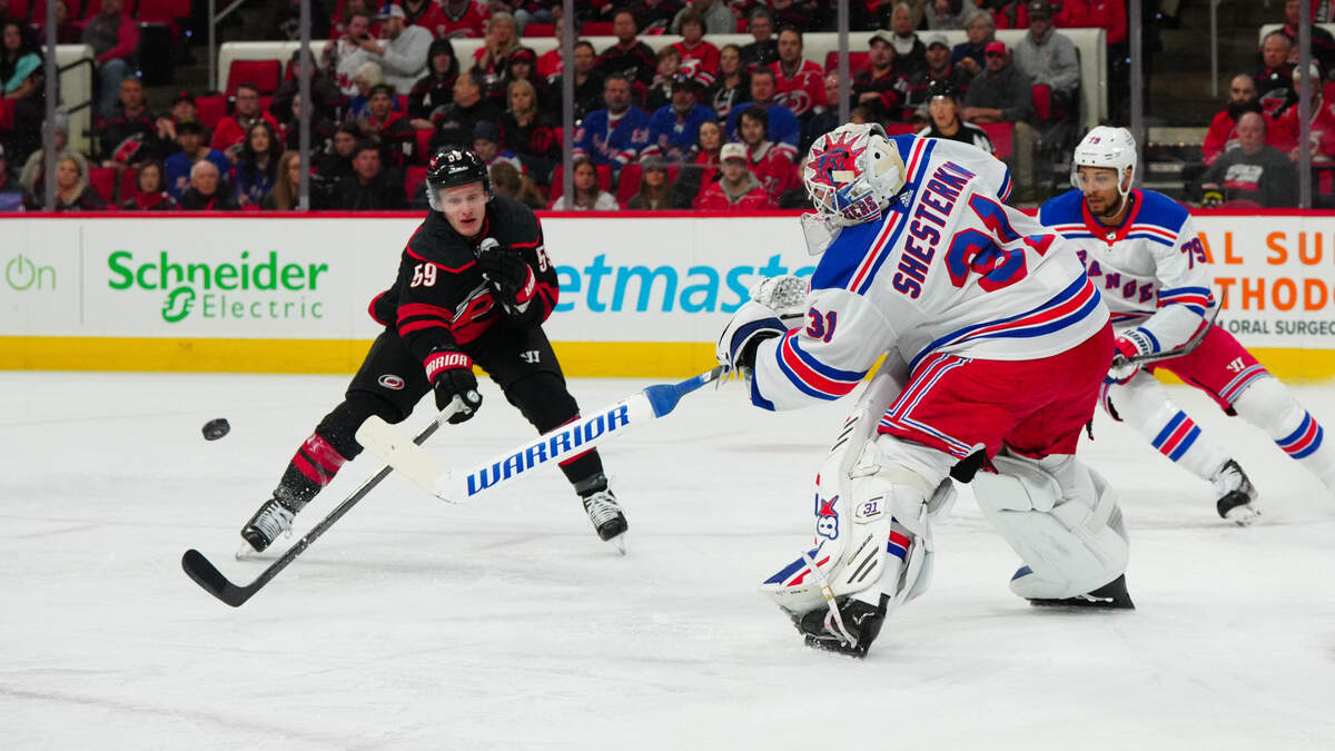 Mar 12, 2024; Raleigh, North Carolina, USA; New York Rangers goaltender Igor Shesterkin (31) clears the puck away from Carolina Hurricanes left wing Jake Guentzel (59) during the first period at PNC Arena. Mandatory Credit: James Guillory-USA TODAY Sports
