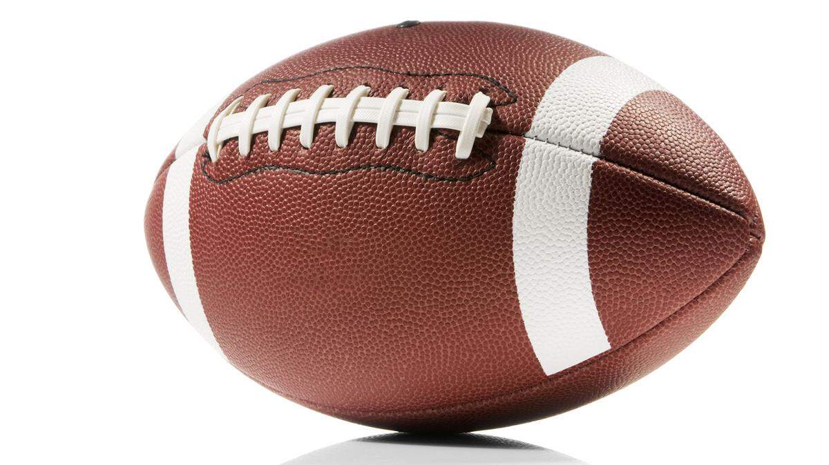 A brown and white american football isolated on a white background with a clipping path. The ball casts a soft shadow on the white background. The leather forms a pitted texture and the ball has white lines painted around it with white laces across the middle. Photo by Getty Images Royalty Free Download