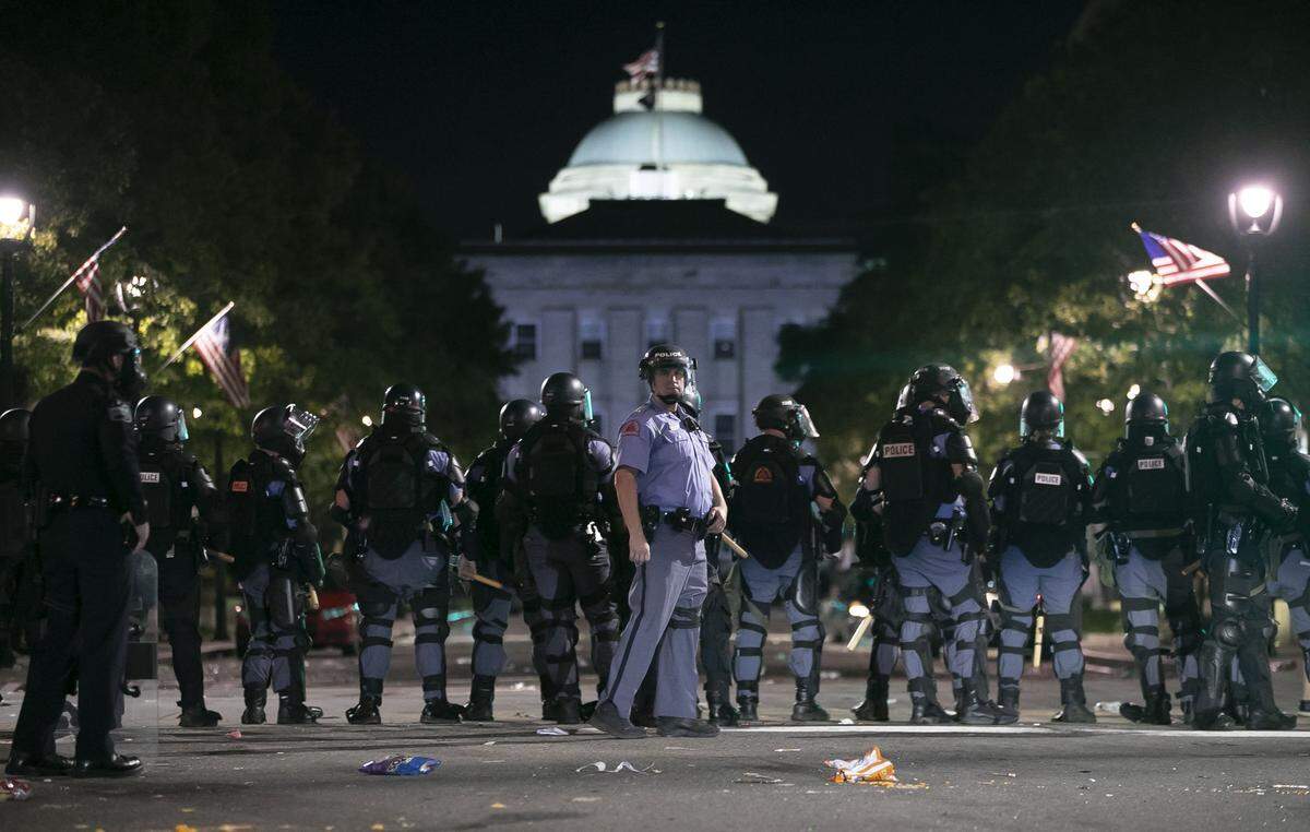 Raleigh Police block Fayetteville Street at Hargett Street as they work to return order after a night of violent demonstrations early Sunday morning May 31, 2020 in Raleigh, N.C.