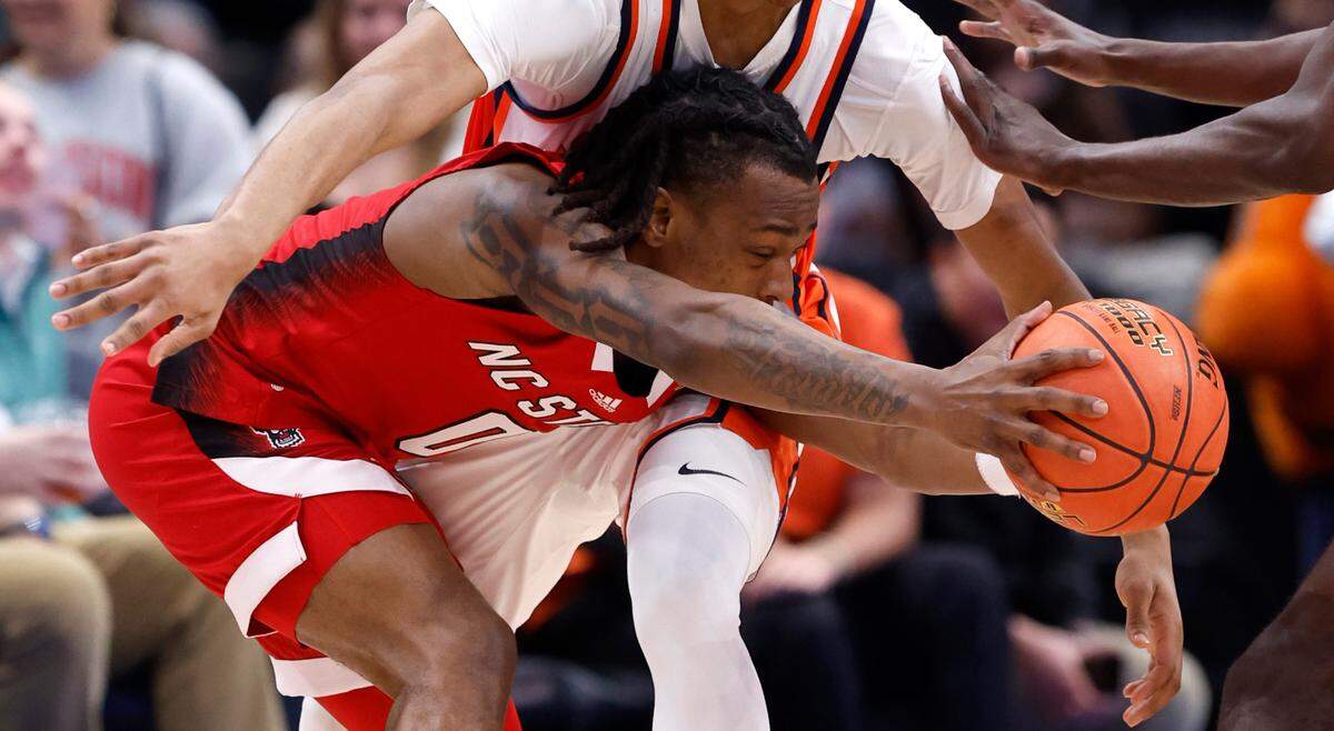 N.C. State’s DJ Horne (0) keeps the ball from Syracuse’s Quadir Copeland (24) during the first half of N.C. State’s game against Syracuse in the second round of the 2024 ACC Men’s Basketball Tournament at Capital One Arena in Washington, D.C., Wednesday, March 13, 2024.