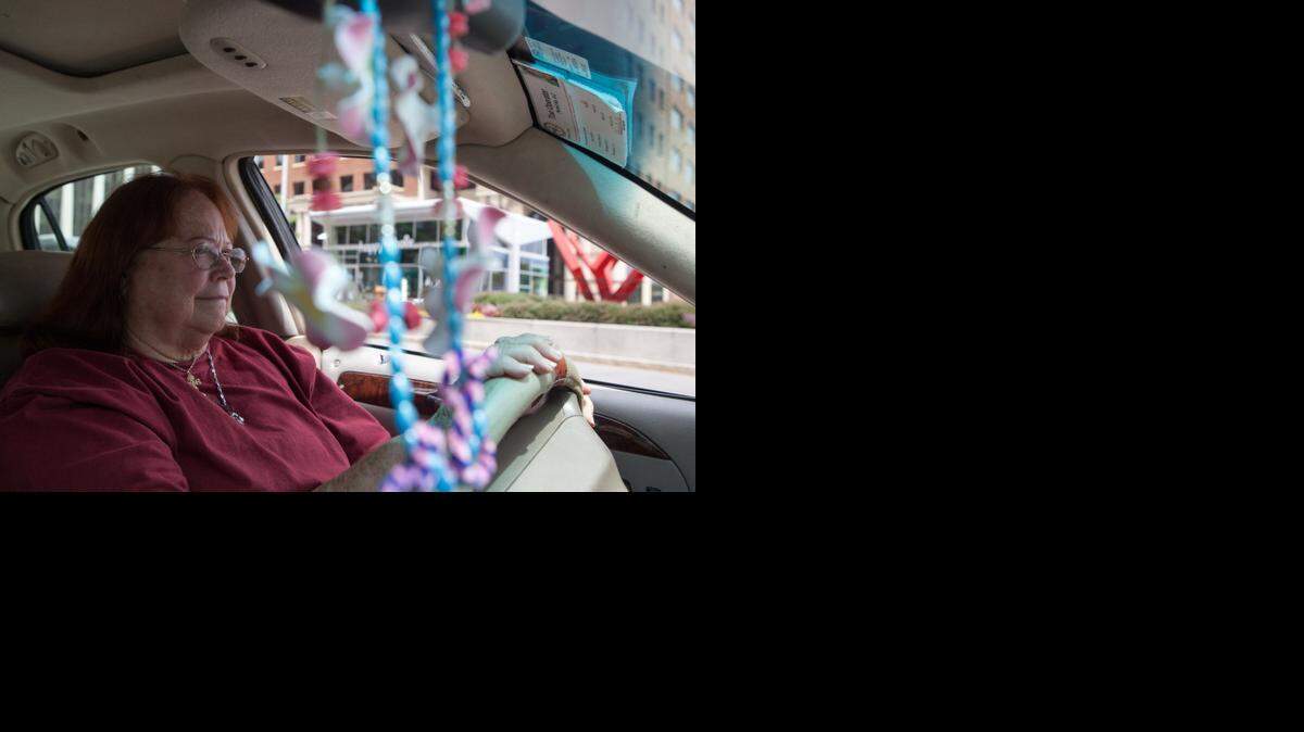 Taxicab driver Lee Churchill waits for a customer on Monday Aug. 11, 2014 in Raleigh. Churchill has seen a decline in her business in the last few months due to a new apps Uber and Lyft that allow users to find cheap rides in private vehicles.
