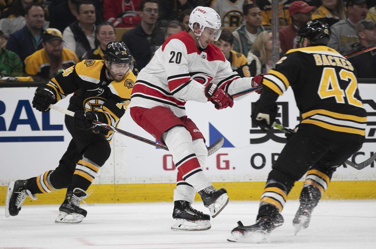 Boston’s Jake DeBrusk (74) and David Backes (42) defend Hurricanes’ Sebastian Aho (20) during the first period of Game 2 of the Eastern Conference finals on Sunday, May 12, 2019 at TD Garden in Boston, Mass.