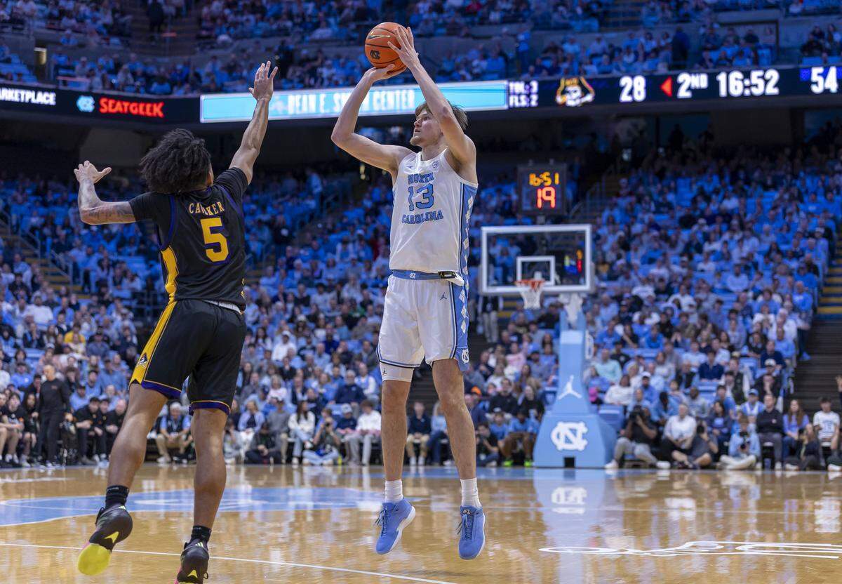 North Carolina center Henri Veesaar (13) puts up a three-point shot against East Carolina guard Corey Caulker (5) in the second half on Monday, December 22, 2025 at the Smith Center in Chapel Hill, N.C. Veesaar scored 16 points in the Tar Heels’ 99-51 victory. 