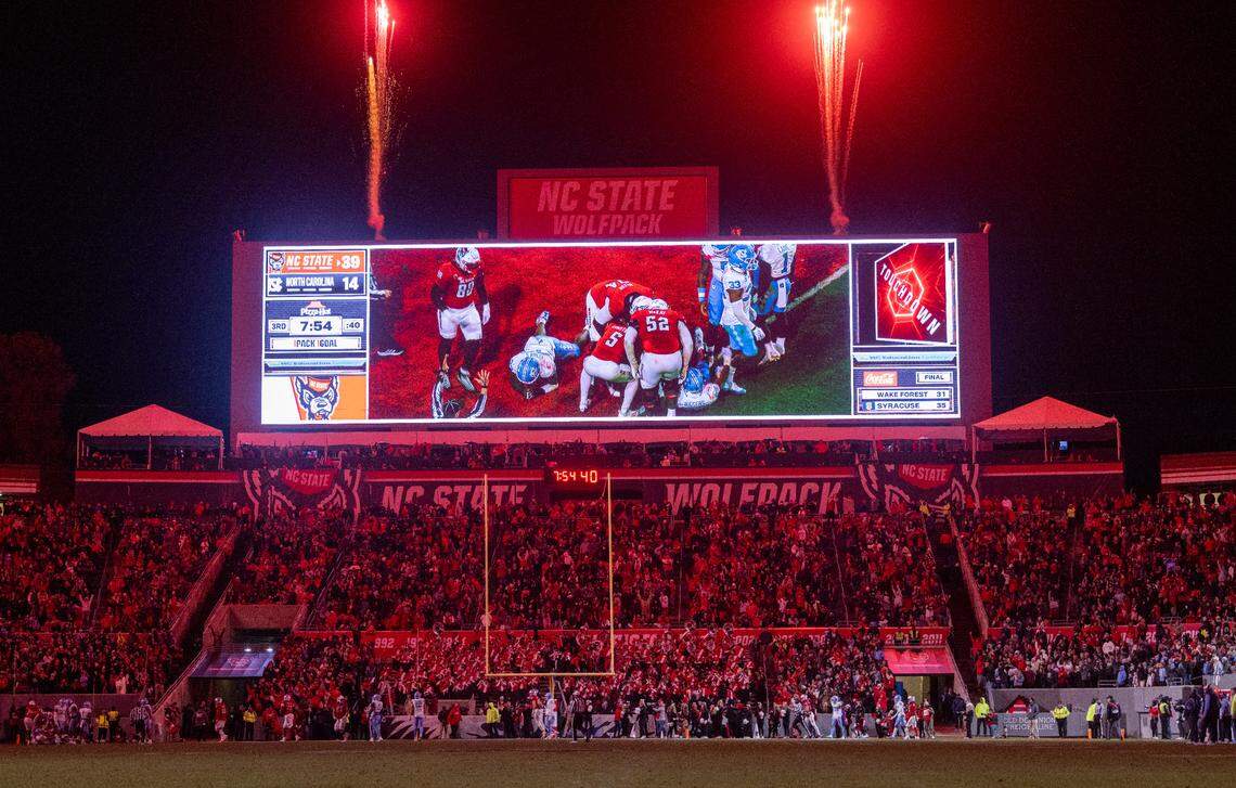 Fireworks illuminate the sky as N.C. State’s Delbert Mimms III scores a touchdown to give the Wolfpack a commanding 39-14 lead in the third quarter against North Carolina on Saturday, November 25, 2023 at Carter-Finley Stadium in Raleigh, N.C.
