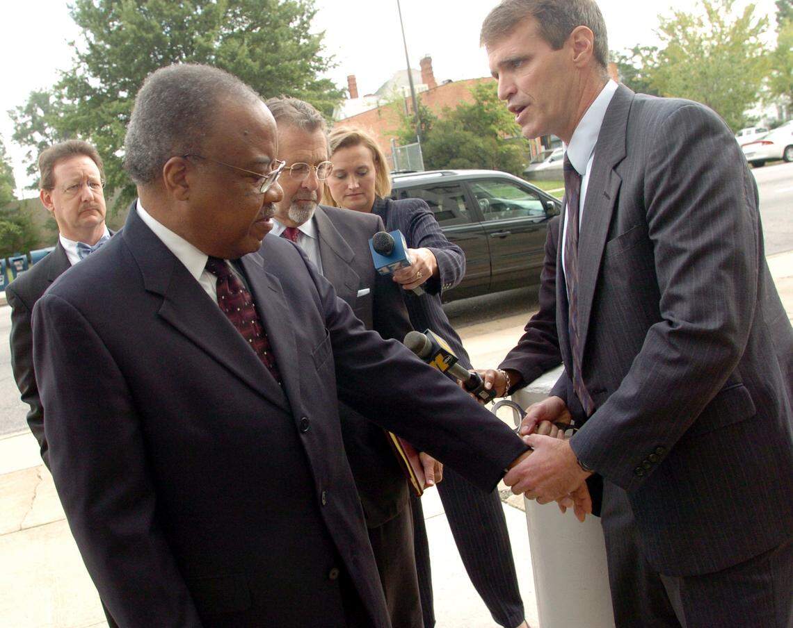 Former U.S. Rep. Frank Ballance is handcuffed by FBI special agent Chuck Stuber after he turned himself in at the United States District Court building in Raleigh.
