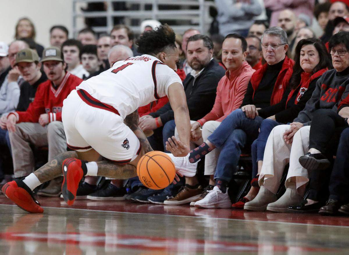 N.C. State’s Darrion Williams attempts to save a ball from going out of bounds during the first half of the Wolfpack’s 76-61 loss to Virginia on Saturday, Jan. 3, 2026, at Lenovo Center in Raleigh, N.C.
