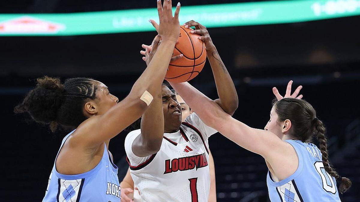 DULUTH, GEORGIA - MARCH 7: Reyna Scott (1) of the Louisville Cardinals drives between Indya Nivar (24) and Lanie Grant (0) of the North Carolina Tar Heels during the first quarter of the semifinals of the Women’s ACC Tournament between the Louisville Cardinals and North Carolina Tar Heels at Gas South Arena on March 7, 2026 in Duluth, Georgia.