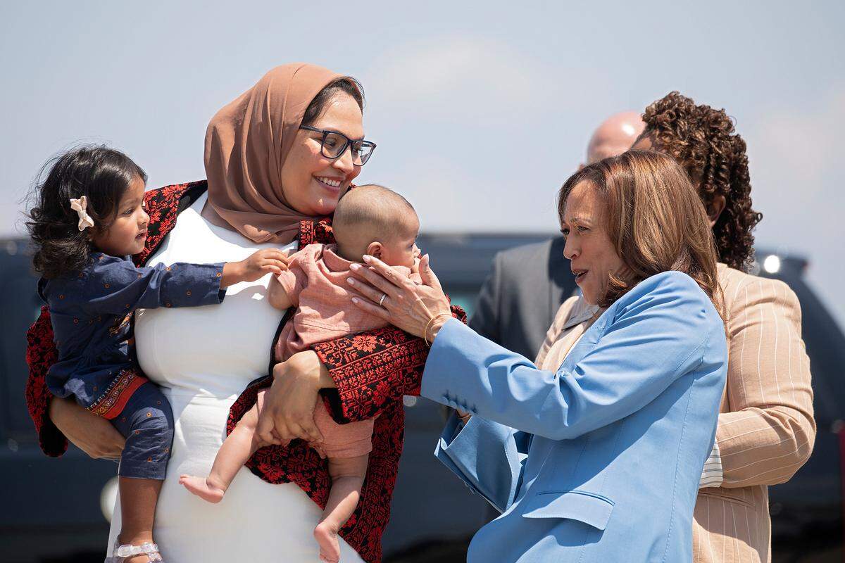 Vice President Kamala Harris greets little Abdul Allam Aziz, son of Durham County Board of Commissioners Chair Nida Allam as she works the receiving line after arriving at RDU in advance of her speech later in the day in Raleigh, N.C., Friday, Aug. 16, 2024. Allam is also holding daughter Aaliyah.
