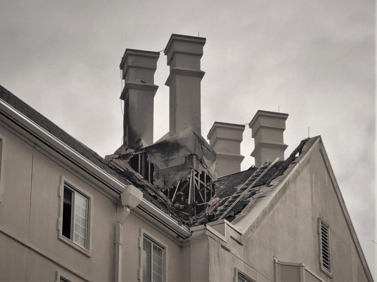 Damage is visible on the roof and chimneys at the Washington Duke Inn near the Duke University campus in Durham, North Carolina, after a fire Friday morning, Dec. 6, 2019.