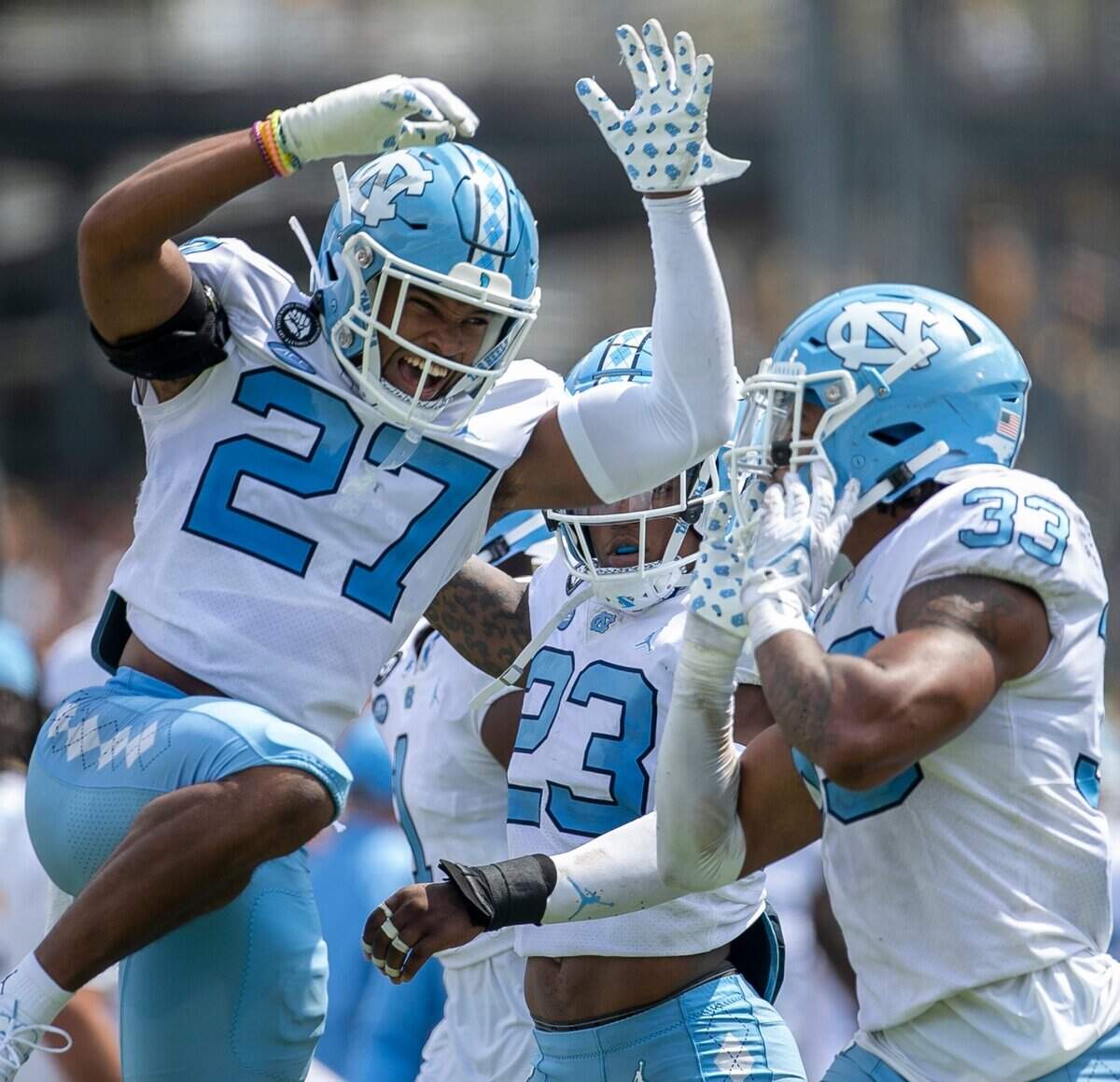 North Carolinas Giovanni Biggers (27) celebrates with teammate Cedric Gray (33), after Grays interception in the third quarter on Saturday, September 3, 2022 at Kidd Brewer Stadium in Boone, N.C.