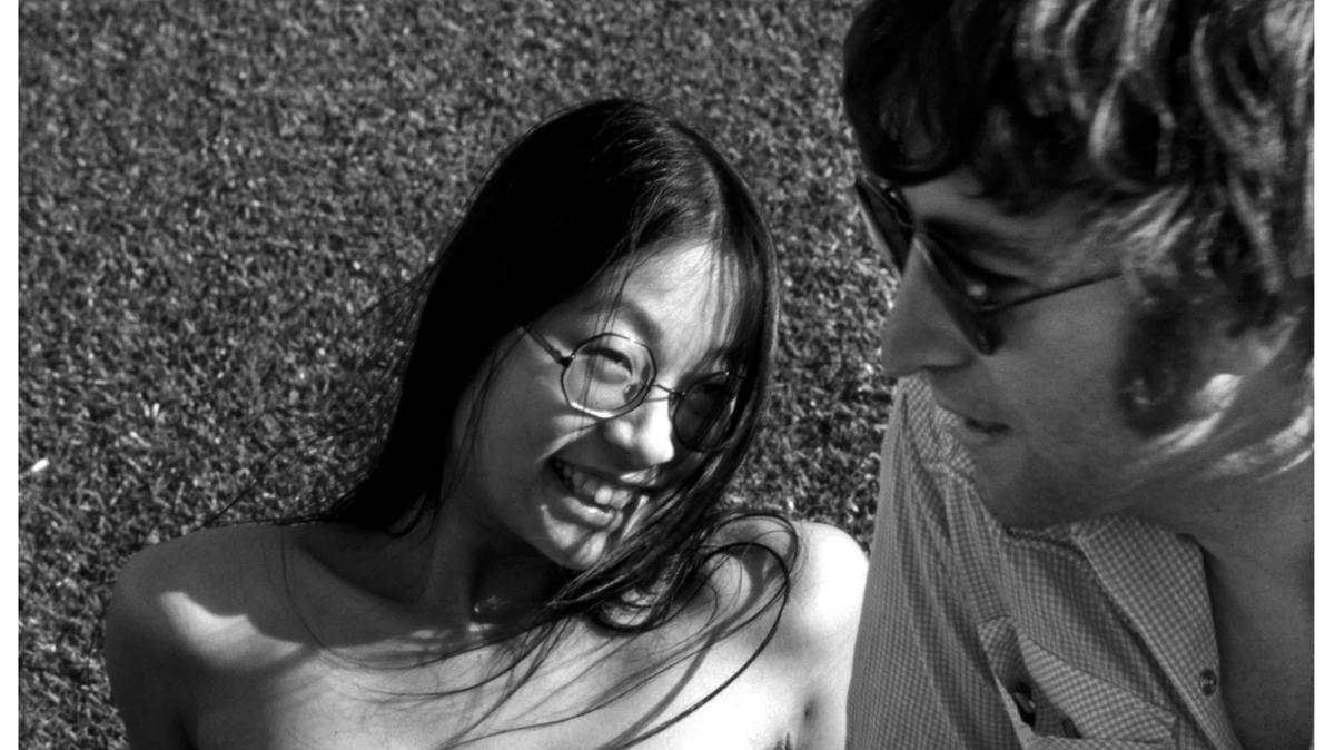 May Pang and John Lennon enjoy a relaxed moment in this candid shot from the exhibit, “The Lost Weekend: The Photography of May Pang,” coming to Chapel Hill and Charlotte in November 2024.