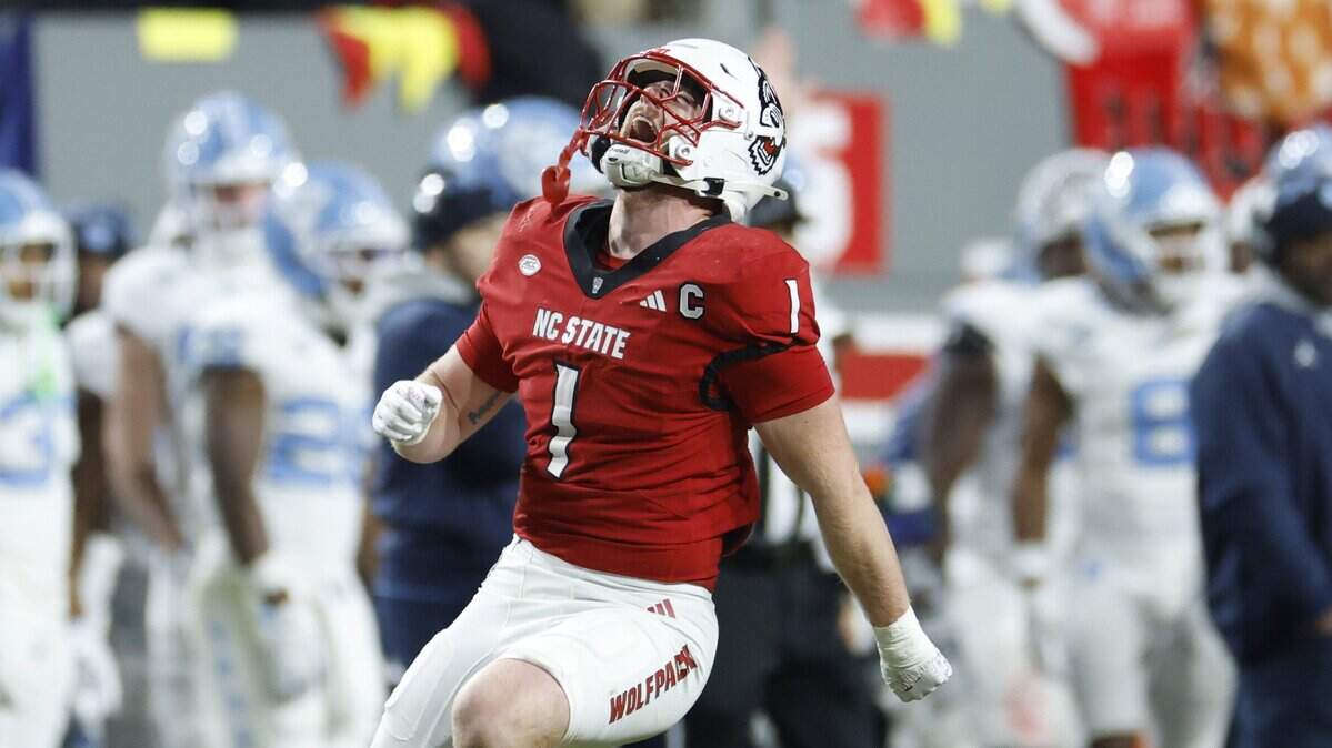 N.C. State linebacker Caden Fordham (1) celebrates after sacking North Carolina quarterback Gio Lopez during the first half of N.C. State’s game against UNC at Carter-Finley Stadium in Raleigh, N.C., Saturday, Nov. 29, 2025.