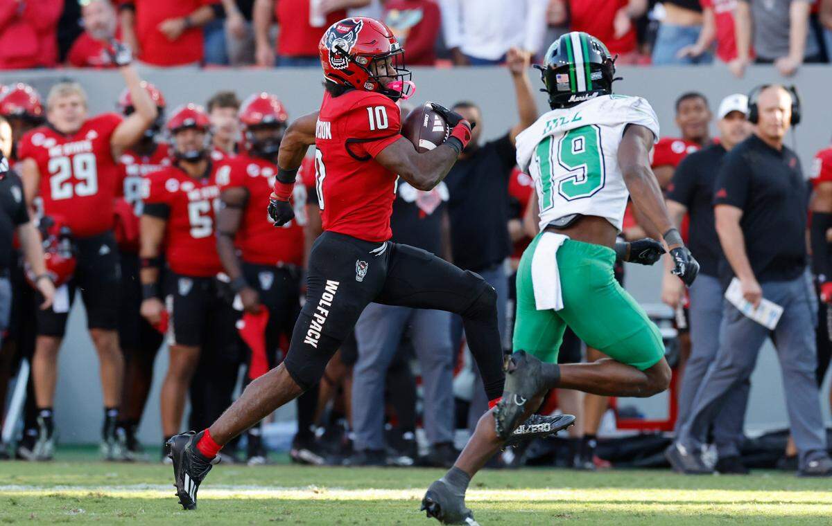 N.C. State wide receiver KC Concepcion (10) looks to avoid Marshall defensive back Dyoni Hill (19) during the second half of N.C. State’s 48-41 victory over Marshall at Carter-Finley Stadium in Raleigh, N.C., Saturday, Oct. 7, 2023.