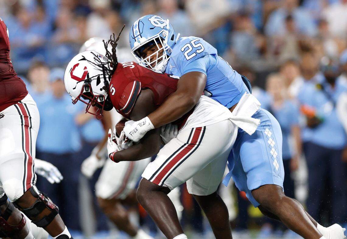North Carolina linebacker Kaimon Rucker (25) tackles South Carolina running back Dakereon Joyner (5) during the first half of UNC’s game against South Carolina in the Duke’s Mayo Classic at Bank of America Stadium in Charlotte, N.C., Saturday, Sept. 2, 2023.