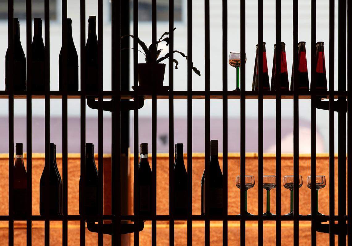 A shelf featuring wines and glassware is seen in the retail market of Redstart Takeaway on Wednesday, Aug. 28, 2024, in Durham, N.C.