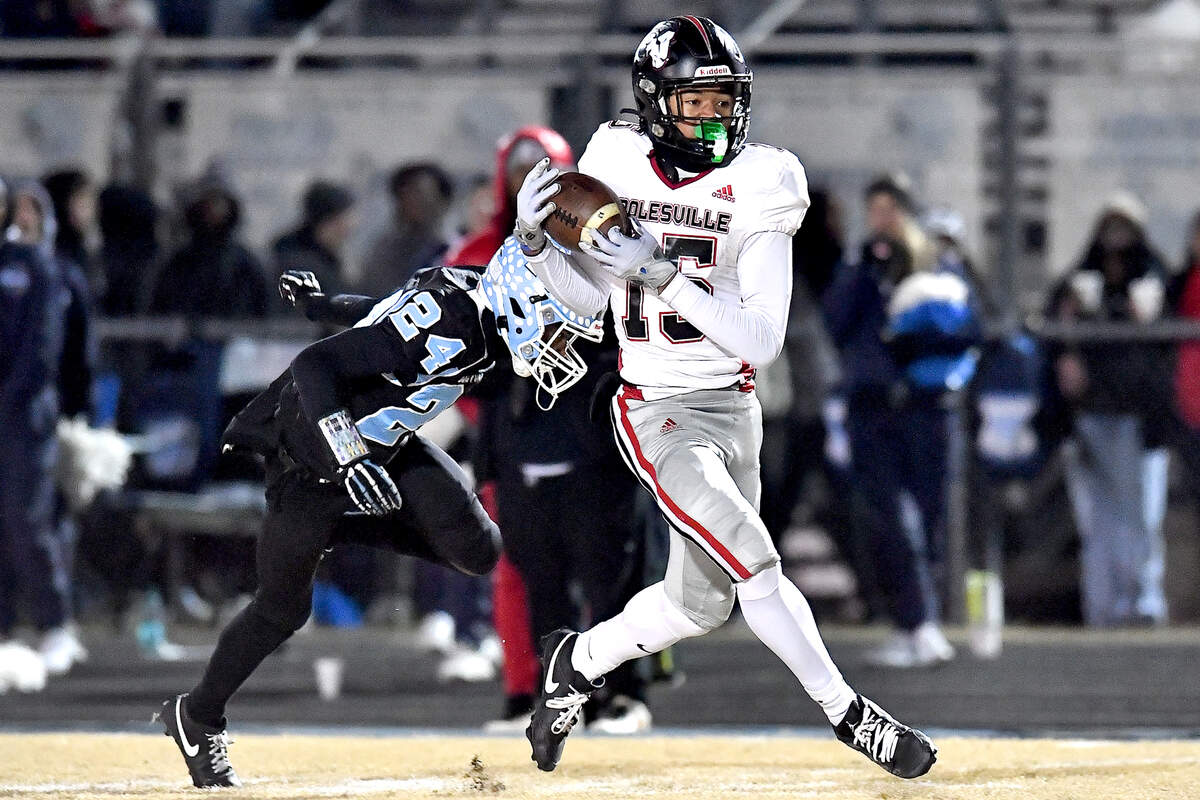 Rolesville wide receiver Anthony Roberts (15) makes the catch against Cleveland defensive back Theron Batiste (24) and runs for the touchdown during the first half. The Rolesville Rams and the Cleveland Rams met in the fourth round of the NCHSAA 4A football playoffs in Clayton, N.C. on December 6, 2024.