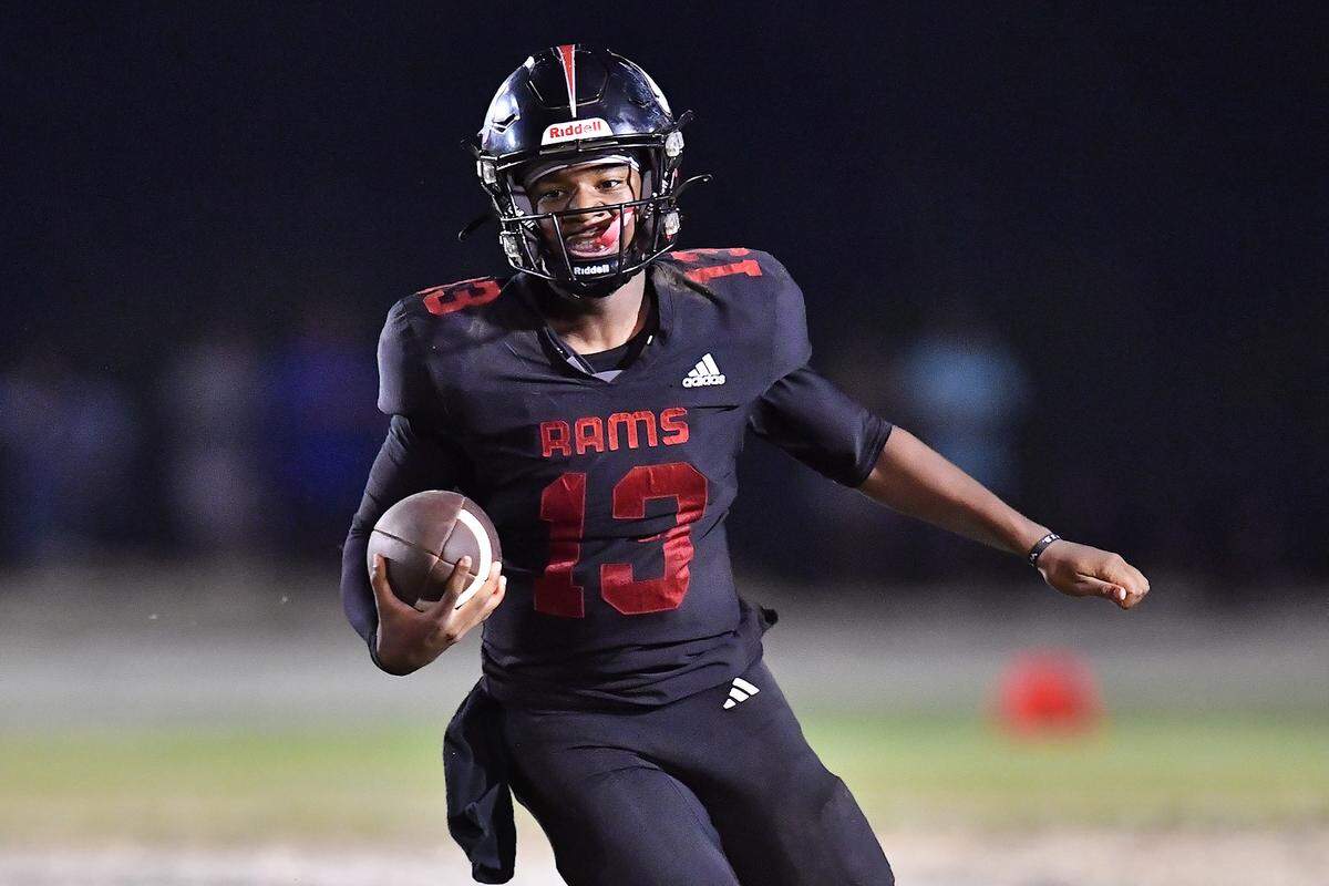 Rolesville quarterback Kaleb Williams (13) runs for yardage against Millbrook during the second half. The Millbrook Wildcats and the Rolesville Rams met in a conference football game in Rolesville, N.C. September 26, 2025