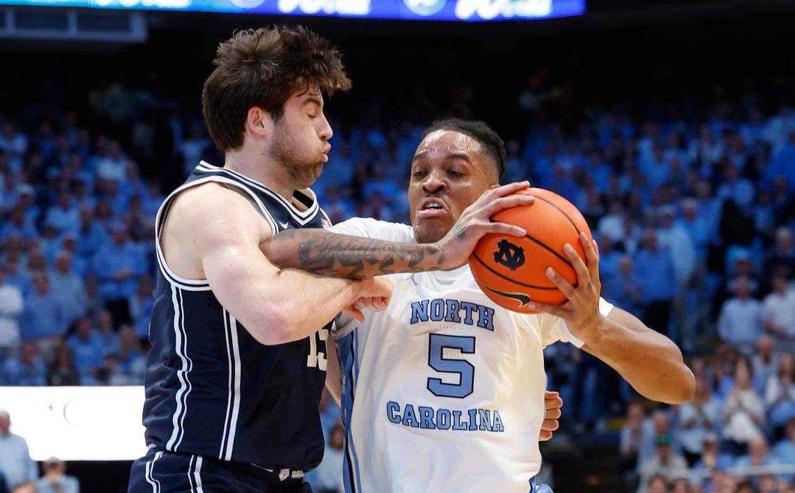 North Carolina’s Armando Bacot (5) drives around Duke’s Ryan Young (15) during the first half of Duke’s game against UNC at the Smith Center in Chapel Hill, N.C., Saturday, Feb. 3, 2024.