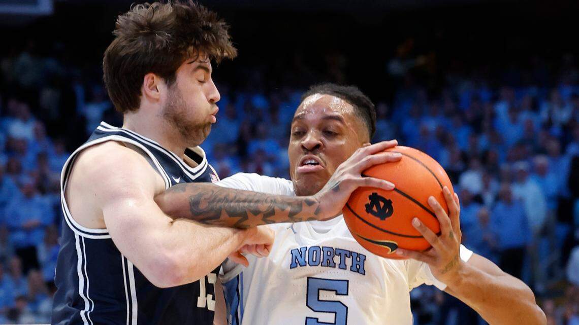North Carolina’s Armando Bacot (5) drives around Duke’s Ryan Young (15) during the first half of Duke’s game against UNC at the Smith Center in Chapel Hill, N.C., Saturday, Feb. 3, 2024.