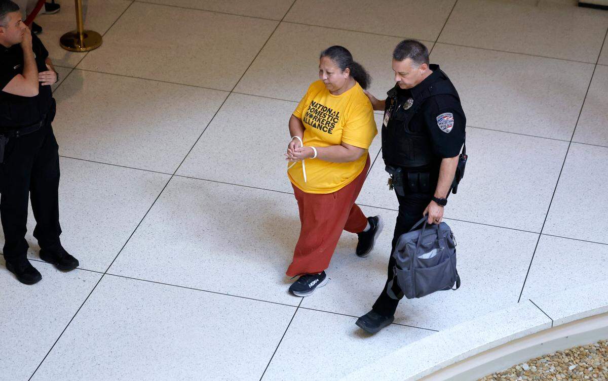 A protester is led away after being arrested outside the doors of the N.C. Senate chambers in Raleigh, N.C., Wednesday, June 26, 2024.