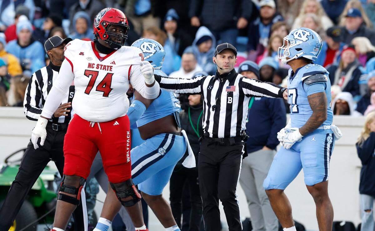 N.C. State offensive tackle Anthony Belton (74) has words with North Carolina linebacker Amare Campbell (17) during the first half of N.C. State’s game against UNC at Kenan Stadium in Chapel Hill, N.C., Saturday, Nov. 30, 2024.