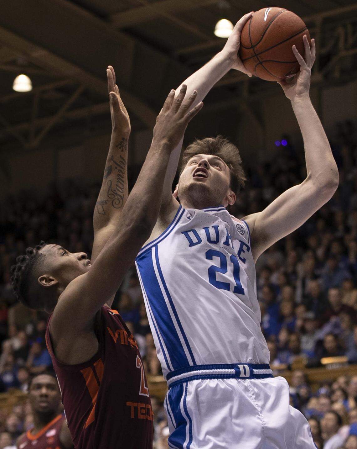 Duke’s Matthew Hurt (21) muscles his way to the basket against Virginia Tech’s Landers Nolley II (2) during the first half on Saturday, February 22, 2020 at Cameron Indoor Stadium in Durham, N.C. Hurt scored 16 points.