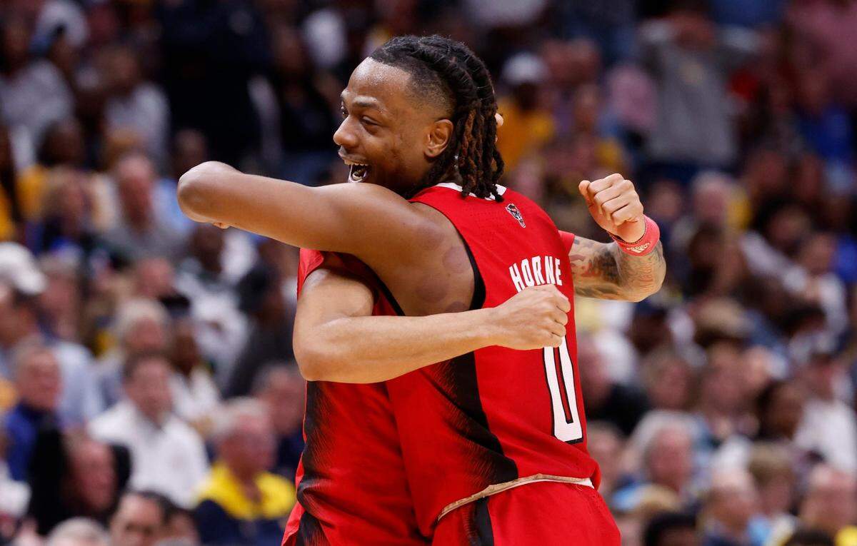 N.C. State’s DJ Horne (0) celebrates with Breon Pass (10) as he comes out of the game late in the second half of N.C. State’s 67-58 victory over Marquette in their NCAA Tournament Sweet 16 game at the American Airlines Center in Dallas, Texas, Friday, March 29, 2024.