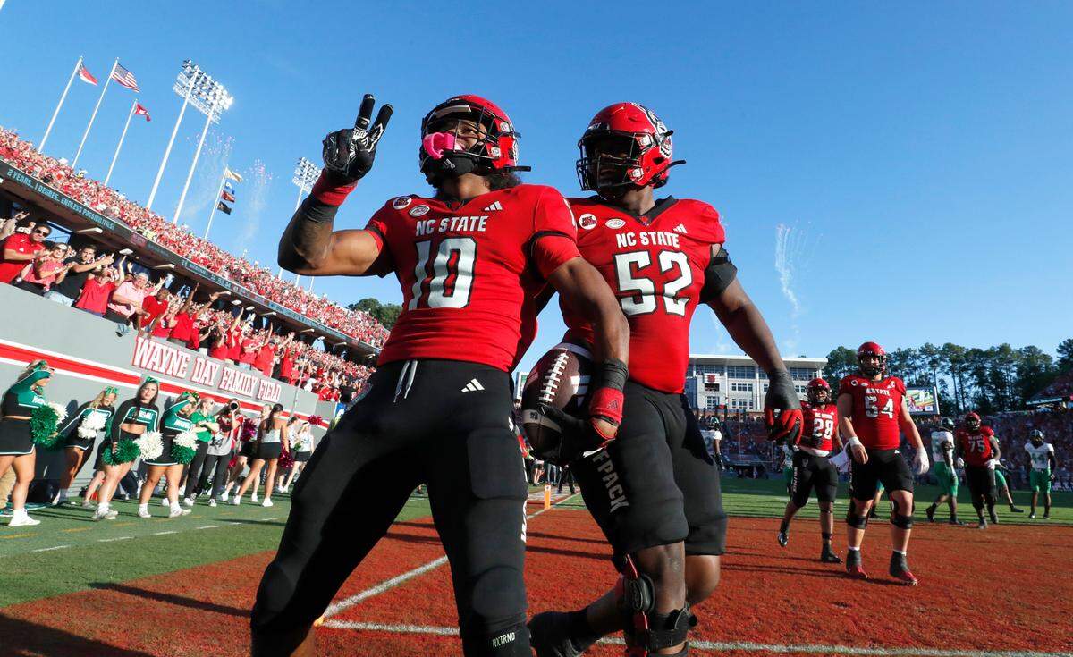 N.C. State wide receiver KC Concepcion (10) celebrates with lineman Timothy McKay (52) after scoring on a 8-yard touchdown reception during the second half of N.C. State’s 48-41 victory over Marshall at Carter-Finley Stadium in Raleigh, N.C., Saturday, Oct. 7, 2023.