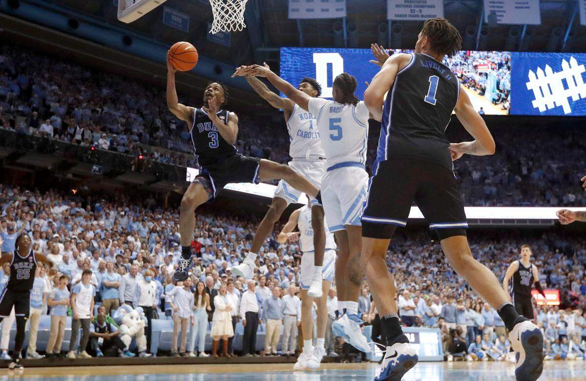 Duke’s Jeremy Roach (3) drives between North Carolina’s Armando Bacot (5) and Leaky Black (1) and makes the basket to put the Blue Devils up 60-57 with 48 seconds left in the game during Duke’s 62-57 victory over UNC at the Smith Center in Chapel Hill, N.C., Saturday, March 4, 2023.