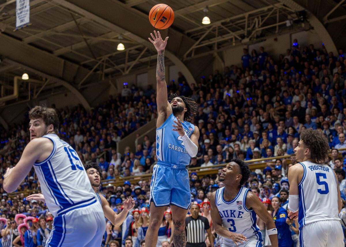 North Carolina’s R.J. Davis (4) scores on the Duke defense of Ryan Young (15), Jared McCain (0), Jeremy Roach (3) and Tyrese Proctor (5) in the second half on Saturday, March 9, 2024 at Cameron Indoor Stadium in Durham, N.C.