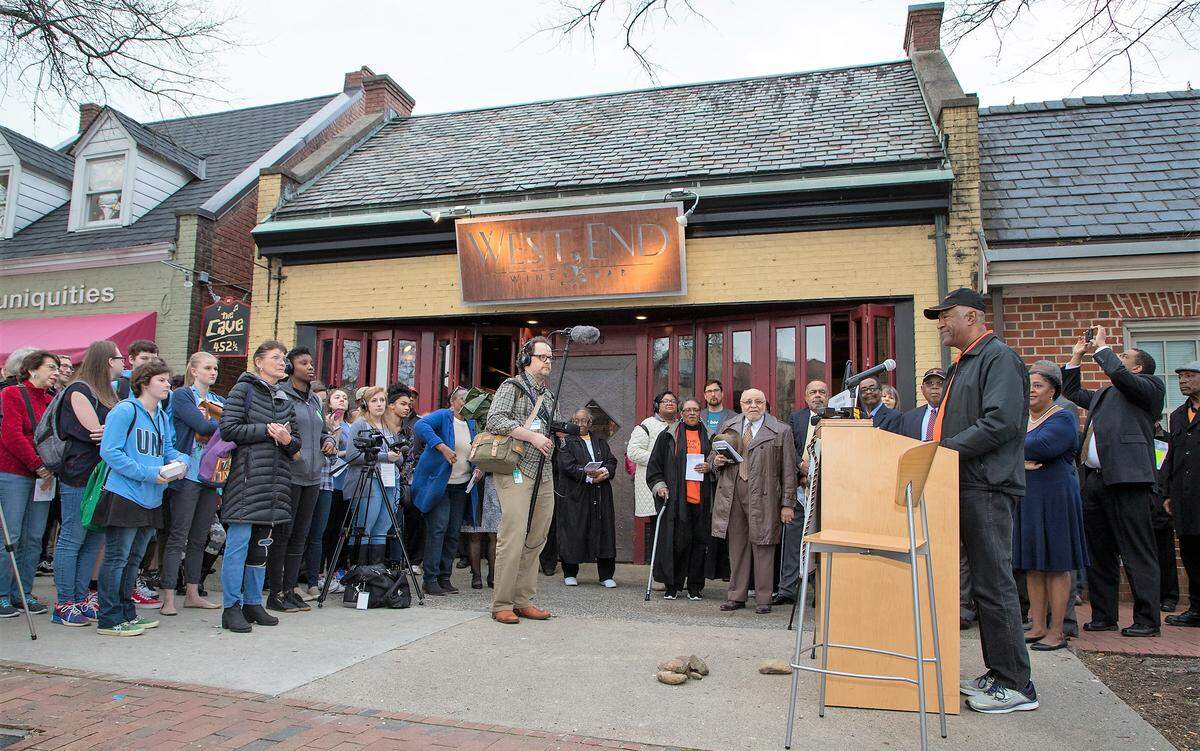 A crowd gathered on March 28, 2019, outside the West End Wine Bar on Franklin Street to hear the story of the Chapel Hill Nine and the town’s plan for a new marker to honor that history. The site is the former Colonial Drug Store, where the teens held a sit-in in 1960.
