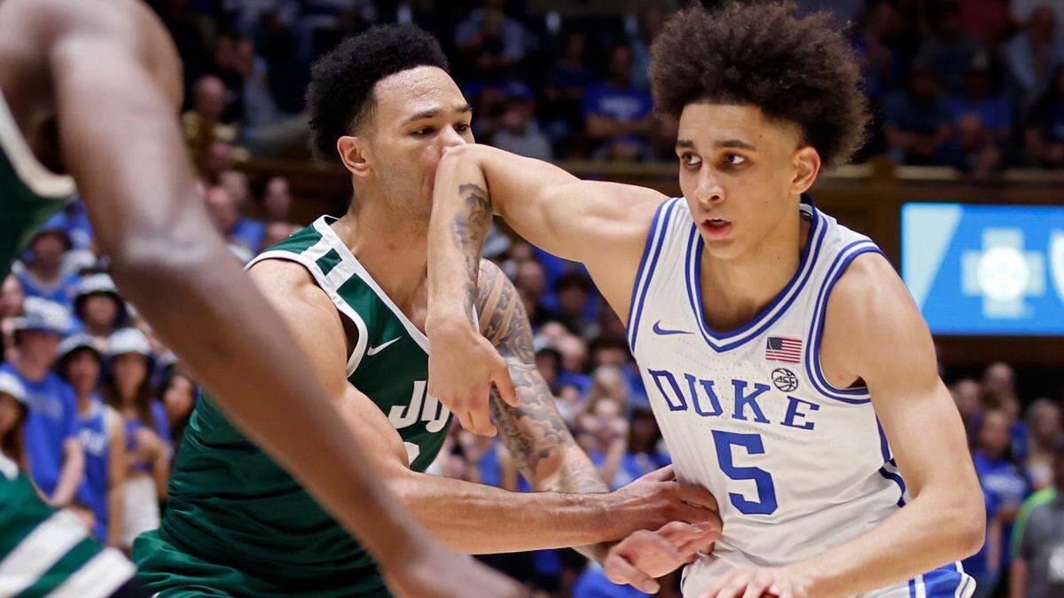 Duke Blue Devils guard Tyrese Proctor drives past Jacksonville Dolphins guard Dylan O’Hearn during the second half of the Blue Devils’ season opener on Monday, Nov. 7, 2022, at Cameron Indoor Stadium in Durham, N.C.
