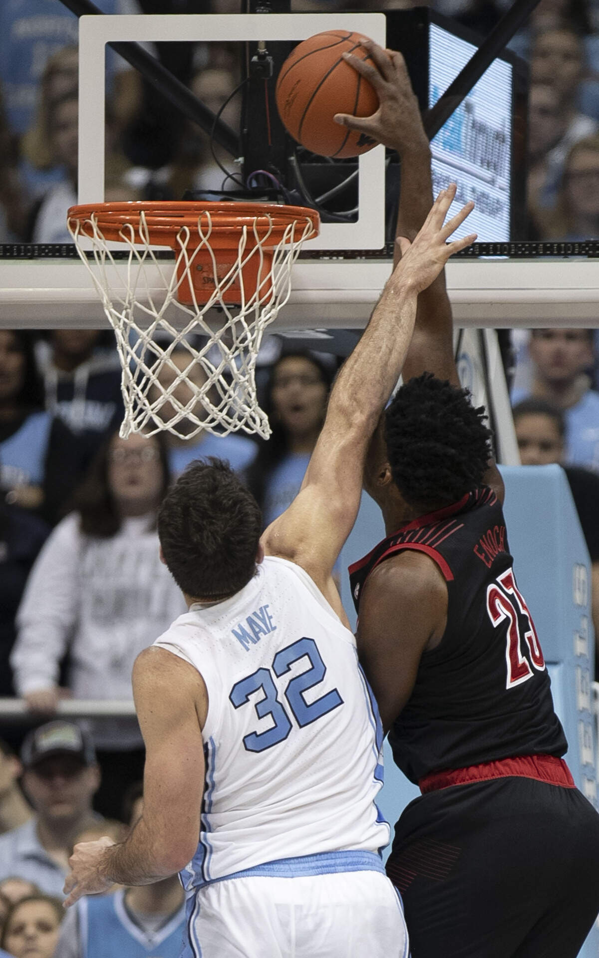 Louisville’s Steven Enoch (23) dunks over North Carolina’s Luke Maye (32) during the first half on Saturday, January 12, 2019 at the Smith Center in Chapel Hill, N.C.