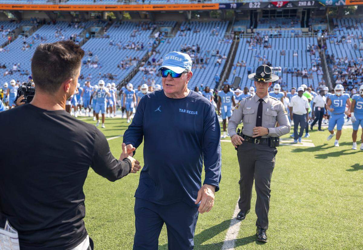 North Carolina coach Mack Brown congratulates James Madison coach Bob Chesney following the Tar Heels’ 70-50 loss on Saturday, September 21, 2024 at Kenan Stadium in Chapel Hill, N.C.
