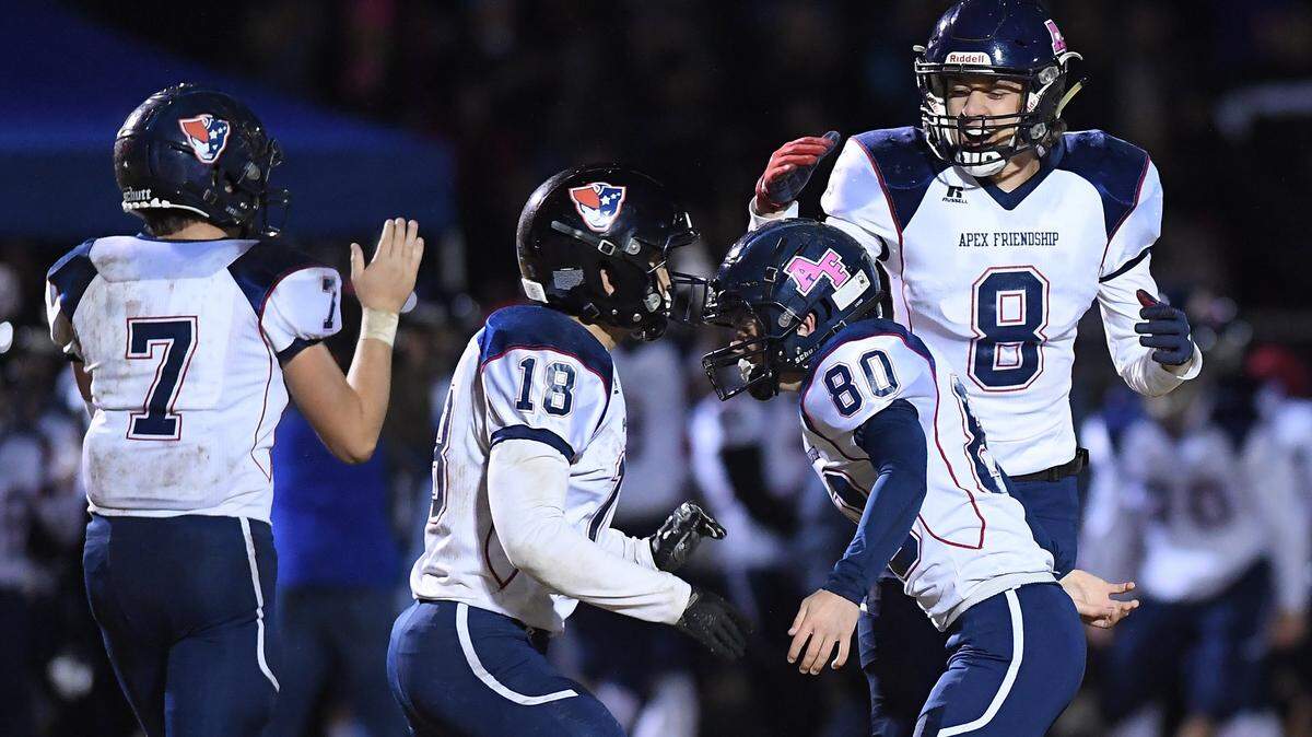 Alan Josephson (80) of Apex Friendship celebrates after scoring the winning field kick along his teammates Nathan Johnson (8), Jakin Burk (18) and Anthony Deberardino (7). The Apex Friendship Patriots visited the Green Hope Falcons in a high school football game on November 15, 2019.