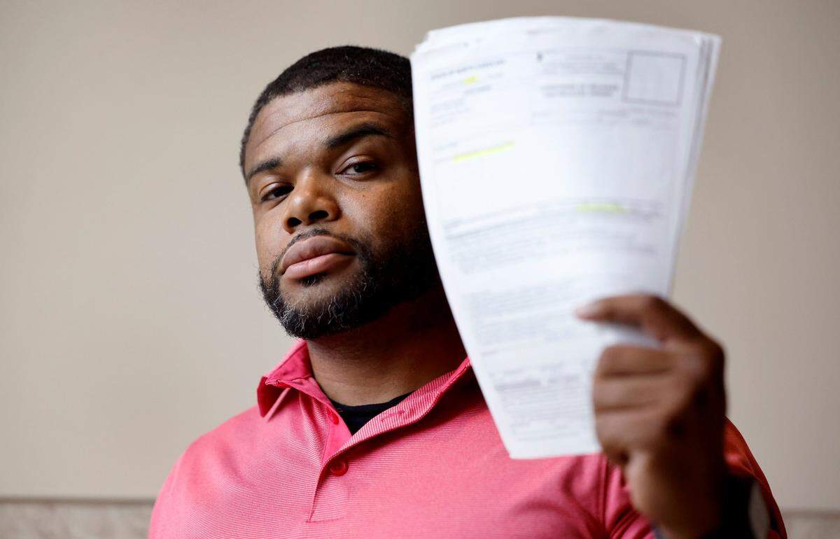 Kevin Spruill holds up release paperwork that he carried in case he was stopped and detained by law enforcement on an arrest warrant that should have been recalled. Spruill is one of several plaintiffs who in 2023 signed onto a potential class action lawsuit alleging that the rollout of the state’s eCourt system violated their civil rights. 