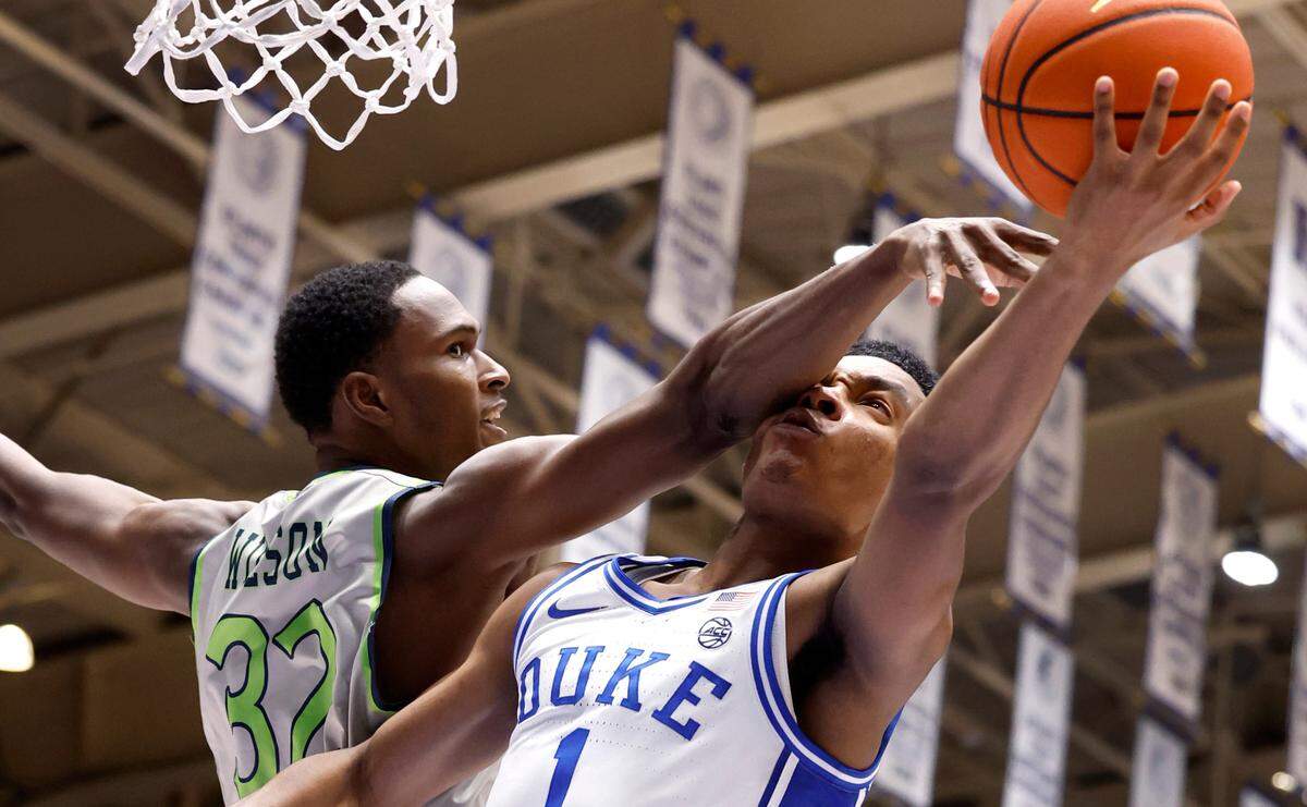 Duke’s Caleb Foster (1) is fouled by Queens’ Malcolm Wilson (32) during the second half of Duke’s 106-69 victory over Queens University at Cameron Indoor Stadium in Durham, N.C., Saturday, Dec. 30, 2023.