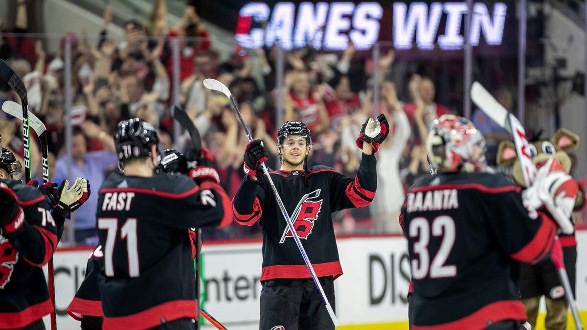Carolina Hurricanesí Jaspers Kotkaniemi (82) and his teammates celebrate their 2-0 victory over the New York Rangers on Friday, May 20, 2022 during game two of the Stanley Cup second round at PNC Arena in Raleigh, N.C.