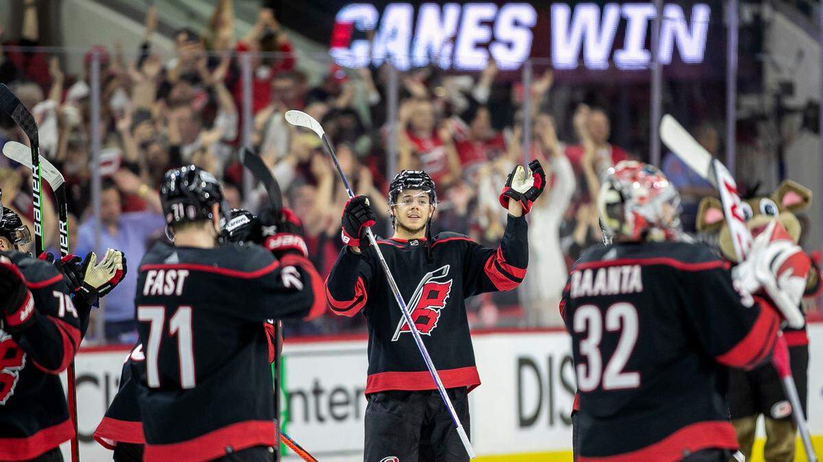 Carolina Hurricanesí Jaspers Kotkaniemi (82) and his teammates celebrate their 2-0 victory over the New York Rangers on Friday, May 20, 2022 during game two of the Stanley Cup second round at PNC Arena in Raleigh, N.C.