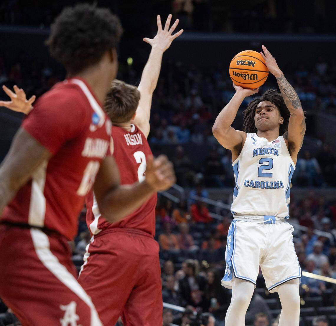 North Carolina’s Elliot Cadeau (2) launches a three point shot over Alabama’s Grant Nelson (2) in the first half during the NCAA Sweet Sixteen on Thursday, March 28, 2024 at Crypto.com Arena in Los Angeles, CA.